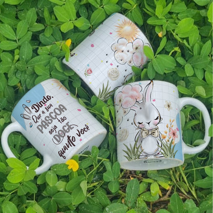 Three mugs with decorative designs on a grass background